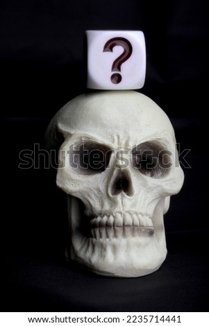 human skull with a question mark symbol on a black background