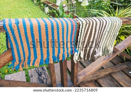 Doormats made from leftover fabric weave until beautiful patterns are cheap and popular in Thailand.