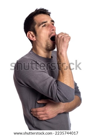 Exhausted young man yawning isolated on white background 