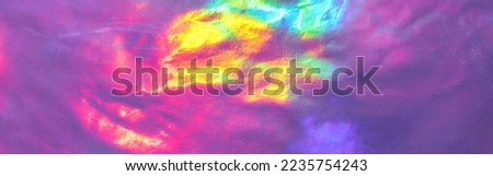 Holographic textures of a banner. Shiny foil and metallic rainbow purple gradient. Fashionable neon hologram with glowing patterns for an elegant background logo or your text. High quality photo