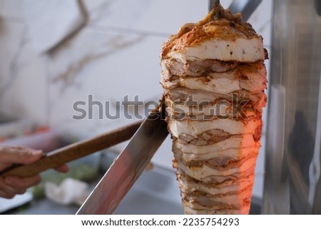Shawarma. Closeup picture of stacked meat roasting, shawarma