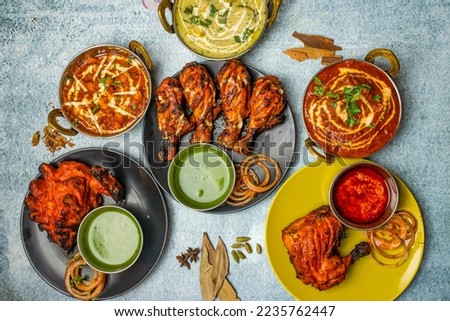 Chicken Tikka Butter Masala, Reshmi masala, Ginger Chicken, Tangri Kabab, Lal Badsha, tandoori, Peri peri, with chili sauce served in a dish isolated on grey background top view of bangladesh food Royalty-Free Stock Photo #2235762447