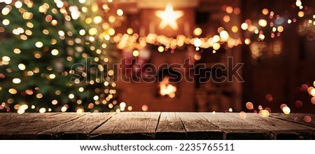 Christmas Tree With Illumination Near the Fireplace. Home Decor Royalty-Free Stock Photo #2235765511