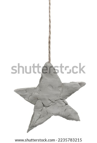 Blank grey modelling clay in star hanging on string, isolated on white