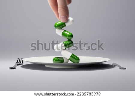 Hand holds pills, tablets on a plate. The concept of serving, giving pills as a lunch, a replacement for traditional food. Modern food service.