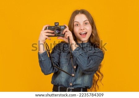 Looking surprised. Surprised teenage photographer holding camera. Surprise