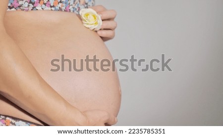 A pregnant woman strokes her belly with a baby before giving birth. Women's health, pregnancy, conception, childbirth concept