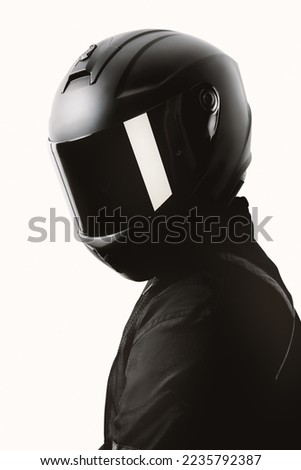 Portrait of a motorcycle rider posing with a black helmet on a white background. Royalty-Free Stock Photo #2235792387