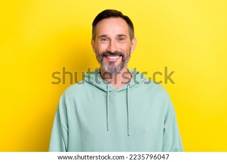 Portrait photo of mature age person man wear blue hoodie sportswear toothy beaming smiling good proposition isolated on yellow color background