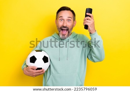 Photo of positive cheerful man football fan scream hooray yes celebrate goal good mood isolated on yellow color background