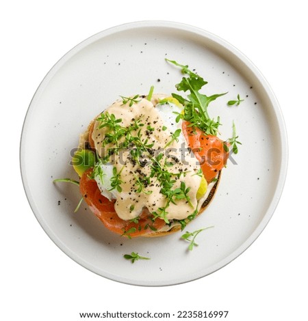eggs Benedict with salmon and avocado on white plate top view isolated on white background Royalty-Free Stock Photo #2235816997