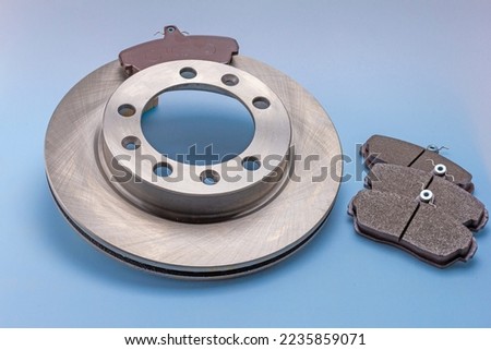 automotive brake parts and components for completing mechanisms and repairing a car on a white-blue milky background.