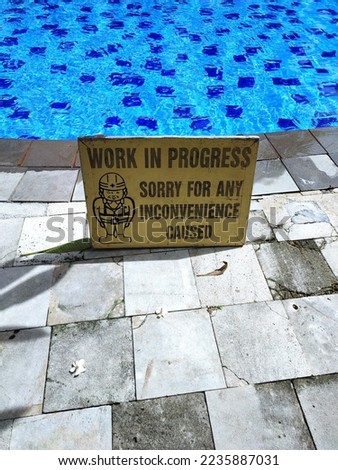 work in progress warning sign in the pool area