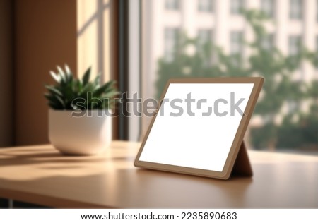 Tablet or smartphone with blank screen on wooden table with blurred bokeh background in modern home window, and sunlight in the morning.