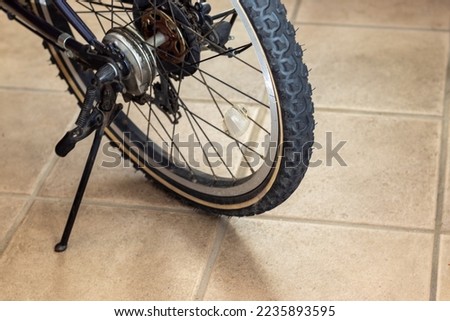 Rear wheel of a bicycle standing on the ground