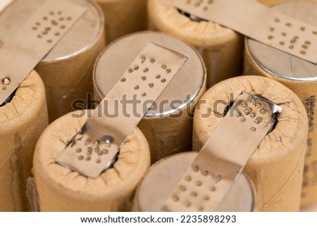 Energy Ideas. Closeup of Bundle of Soldered Ni-Mh Rechargeable Batteries  Placed Together Over Beige.Composition Horizontal Royalty-Free Stock Photo #2235898293