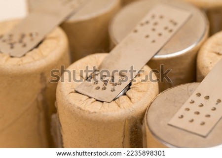 Environment Ideas. Extreme Closeup of Bundle of Soldered Ni-Mh Rechargeable Batteries  Placed Together Over Beige. Horizontal image Royalty-Free Stock Photo #2235898301