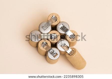 Energy and Environment Ideas. Upper View of Bundle of Soldered Ni-Mh Rechargeable Batteries  Placed Together Over Beige.Horizontal image Royalty-Free Stock Photo #2235898305