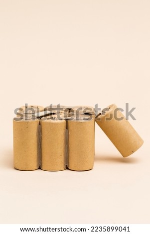 Side View of Bundle of Soldered Ni-Mh Rechargeable Batteries  Placed Together Over Beige.Vertical Orientation Royalty-Free Stock Photo #2235899041