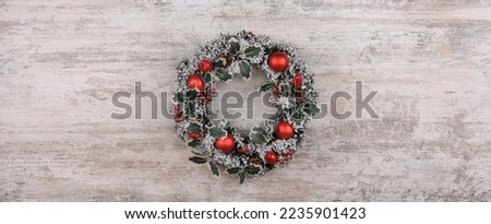 christmas wreath on old white wooden background