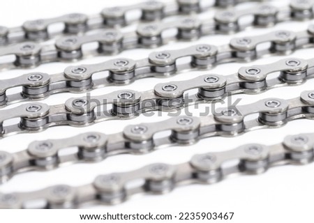 Closeup of New Clean Oiled Bicycle Chain Image Texture Isolated Over White Background With Focus in the Middle of Chain. Horizontal Shot