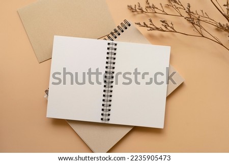 Notebook, A5, A6, metal ring bind, with white cream paper, with dried flowers and envelope. Stationary mockup template.  Royalty-Free Stock Photo #2235905473
