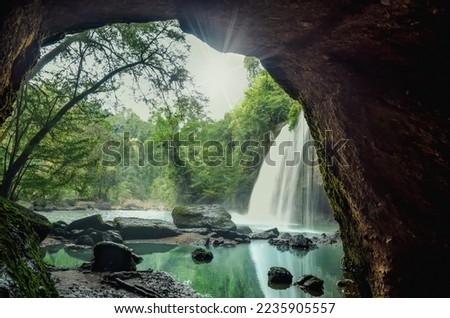 Waterfall in tropical forest at Khao Yai National Park, Waterfall view from inside the cave. Amazing of Haew Suwat Waterfall Unseen Khao Yai National Park, Thailand. Traveling ecotourism.

