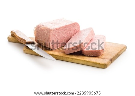 Luncheon meat on cutting board isolated on the white background. Royalty-Free Stock Photo #2235905675