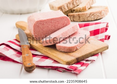 Luncheon meat on the cutting board. Royalty-Free Stock Photo #2235908645