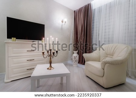 A comfortable living room filled with small details. Light style.