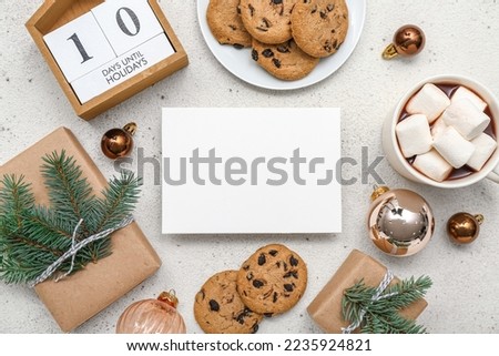 Calendar with text 10 DAYS UNTIL HOLIDAYS, blank card, cookies, cup of cocoa, Christmas gifts and decor on white background