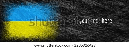 Flag of Ukraine. Flag is painted on black crumpled paper. Paper background. Copy space. Textured creative background