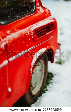 christmas snow on the back of a red car on the street. New Year's photo zone with a real car in a photo studio. white snow on a retro car painted with red paint