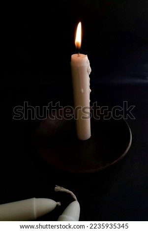a white candle that glows in the dark