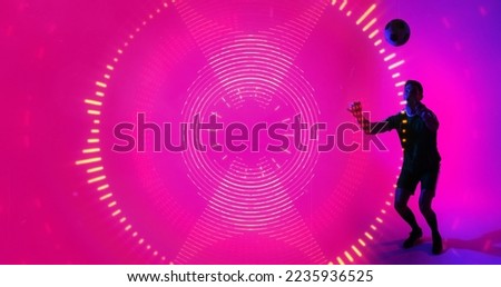 Young soccer player practicing over neon design with pink background. Computer graphic, copy space, abstract, digital composite, design, athlete, skill, sport.