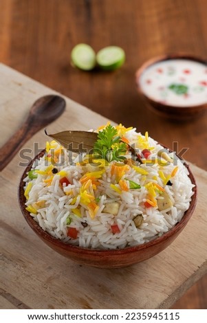 The Indian Pulav vegetables and The rice is browned in oil and then mixed with vegetables nuts, fruits etc. Basmati Rice,Vegetable Rice. with tasty Rayta. Stock Photo.