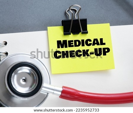 MEDICAL CHECK-UP words on a small yellow piece of paper.
