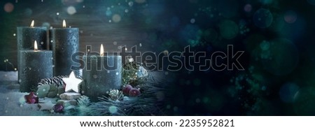 Four burning advent candles in winter season. Christmas background banner with bokeh lights  - xmas card
