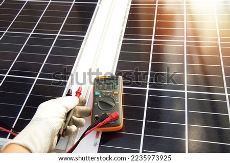Technician inspecting solar panel installation