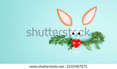 Easter bunny face with a heart shaped nose and whiskers from carrot leaves, holiday greeting card, spring season