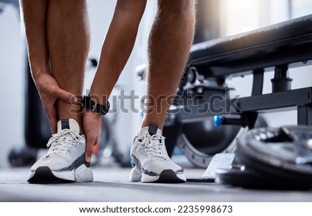 Man legs, fitness and ankle injury in gym for training workout, sports accident or cardio emergency. Athlete person, muscle anatomy or fibromyalgia trauma, joint pain or leg wellness from exercise Royalty-Free Stock Photo #2235998673