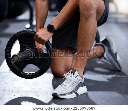 Fitness, gym or hands training with a barbell or heavy equipment for muscle growth or development workout. Shoes, bodybuilder or healthy strong man starting weightlifting strength training exercise Royalty-Free Stock Photo #2235998689