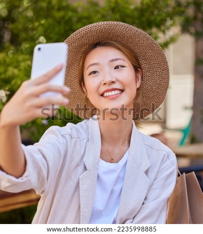 Selfie, smartphone and shopping bag of woman in city or park for social media post, profile picture update and fashion blog in Japan. Cellphone photography, happy woman or influencer with retail tips