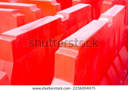 Plastic barriers blocking the road. Red traffic barrier