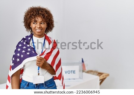 Young african american woman smiling confident wearing united states flag at electoral college