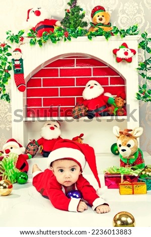 Cute little baby boy in Christmas costume crawling on the floor.
