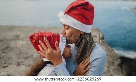 Happy Latin mother having a tender moment with her child during Christmas holidays - Family and holidays concept