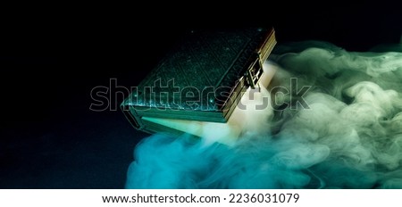 Mysterious glowing antique book on a dark background. Horizontal banner with copy space for popular social media website cover image.