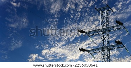 Electricity pylon (high voltage power line) on the background of the cloudy sky