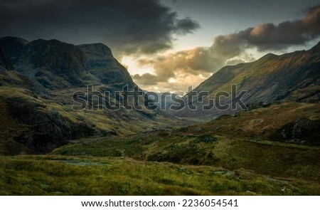 A view into Glencoe, Highlands, Scotland green landscape with views of the mountains. Royalty-Free Stock Photo #2236054541